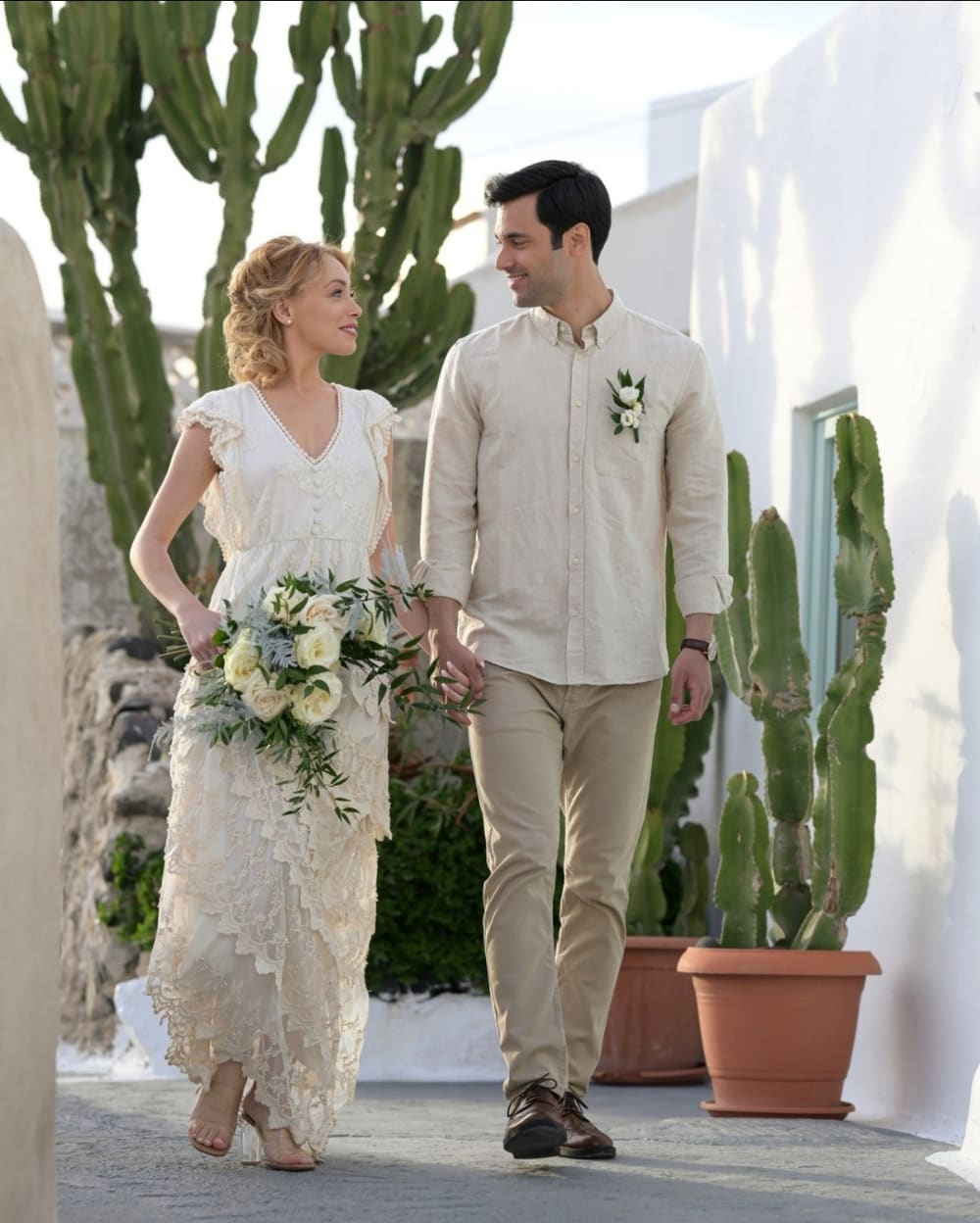 Boho couple walking through Santorini village streets