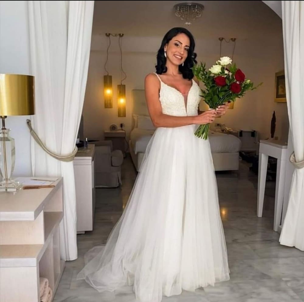 Bride with bouquet in luxury Santorini suite