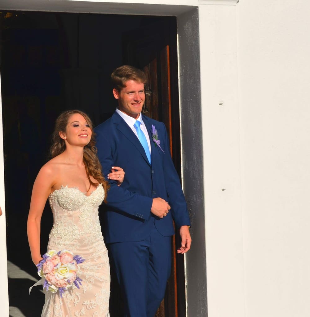 Couple exiting church after ceremony Santorini