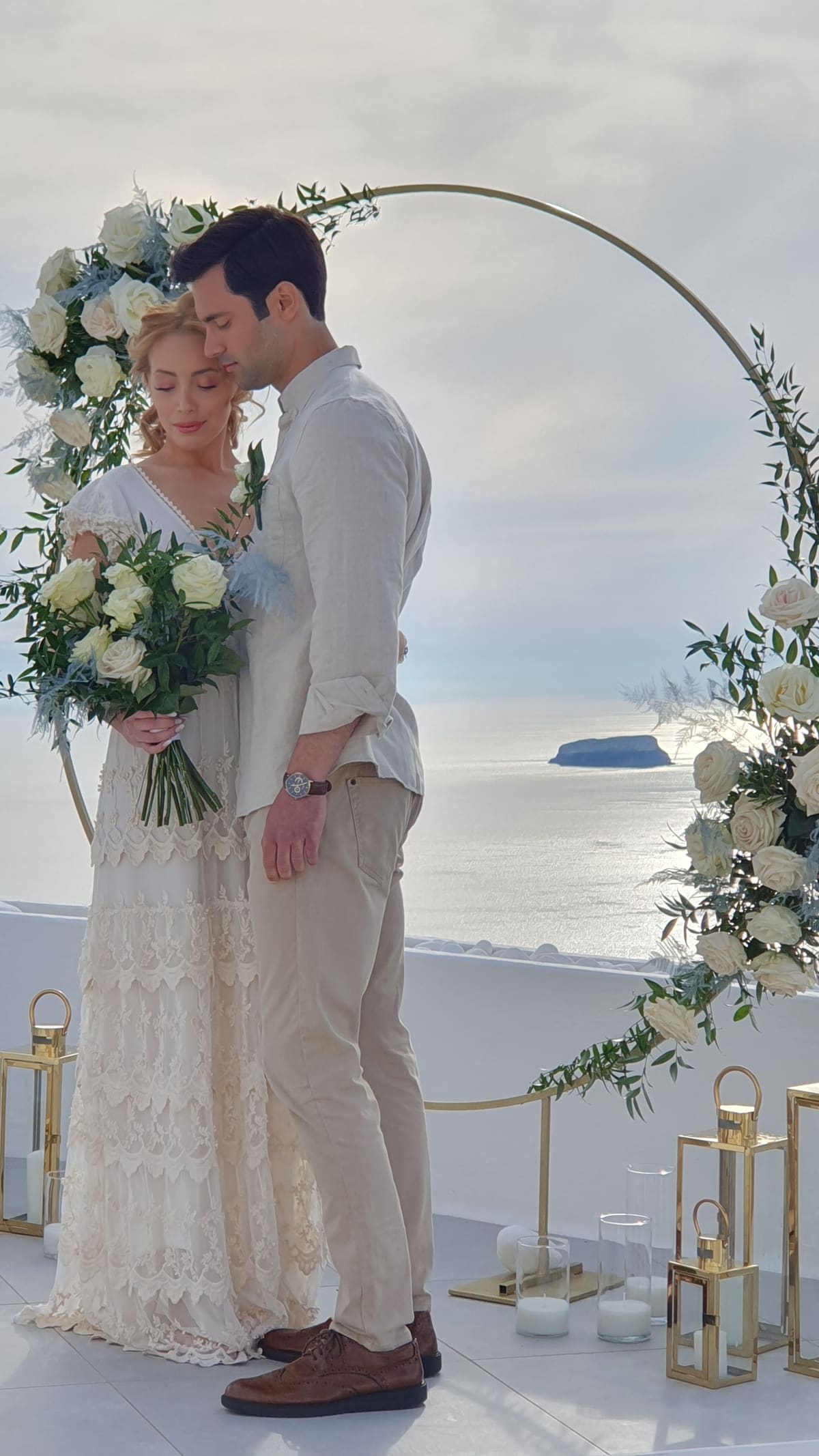 Intimate elopement with circular floral arch in Santorini