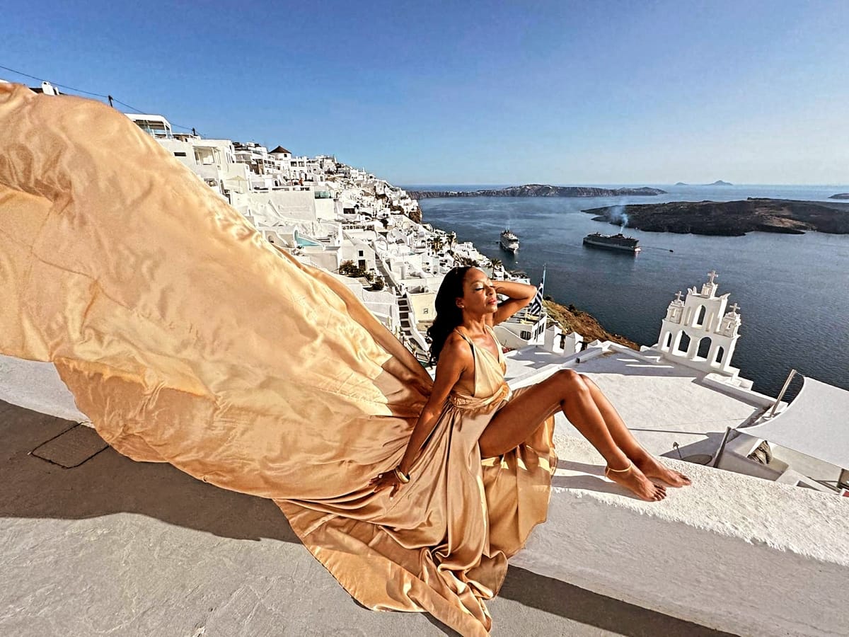 Flying dress photoshoot in green Santorini landscape